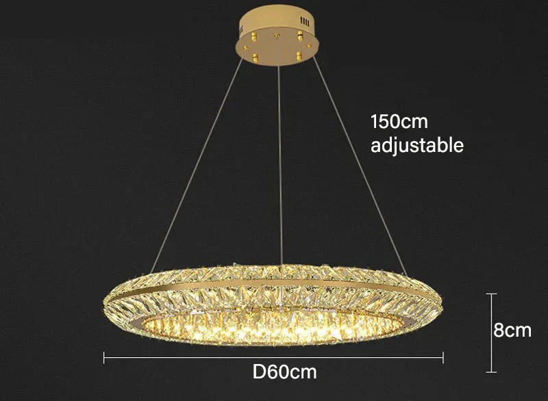 Modern circular crystal LED chandelier with adjustable suspension, warm yellow glow, luxury hotel lighting.