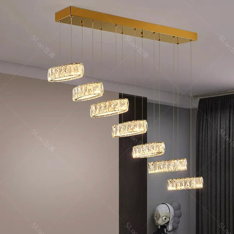 Six rectangular crystal LED chandelier lights hang in a gold mount's descending staircase pattern.