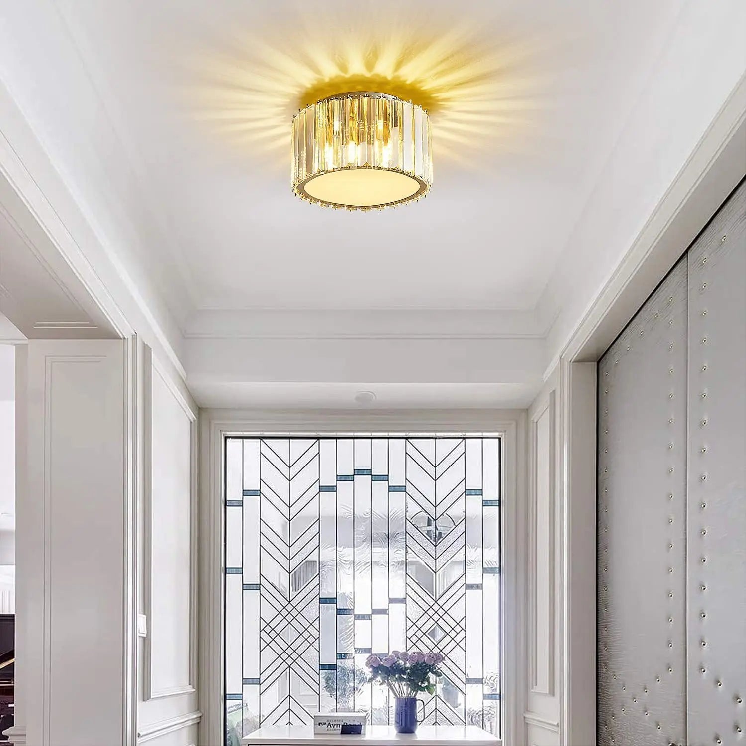 Maison Ornate Luxurious Round Crystal LED chandelier sparkles, creating radiant ceiling patterns above.