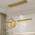 Gold and crystal geometric ring chandelier with two glass pendant spheres and a horizontal bar.
