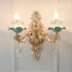 Maison Ornate chandelier with gold detail, green accents, crystal ornaments, and a floral ceramic design.