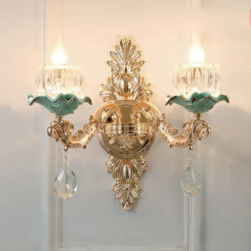Maison Ornate chandelier with gold detail, green accents, crystal ornaments, and a floral ceramic design.