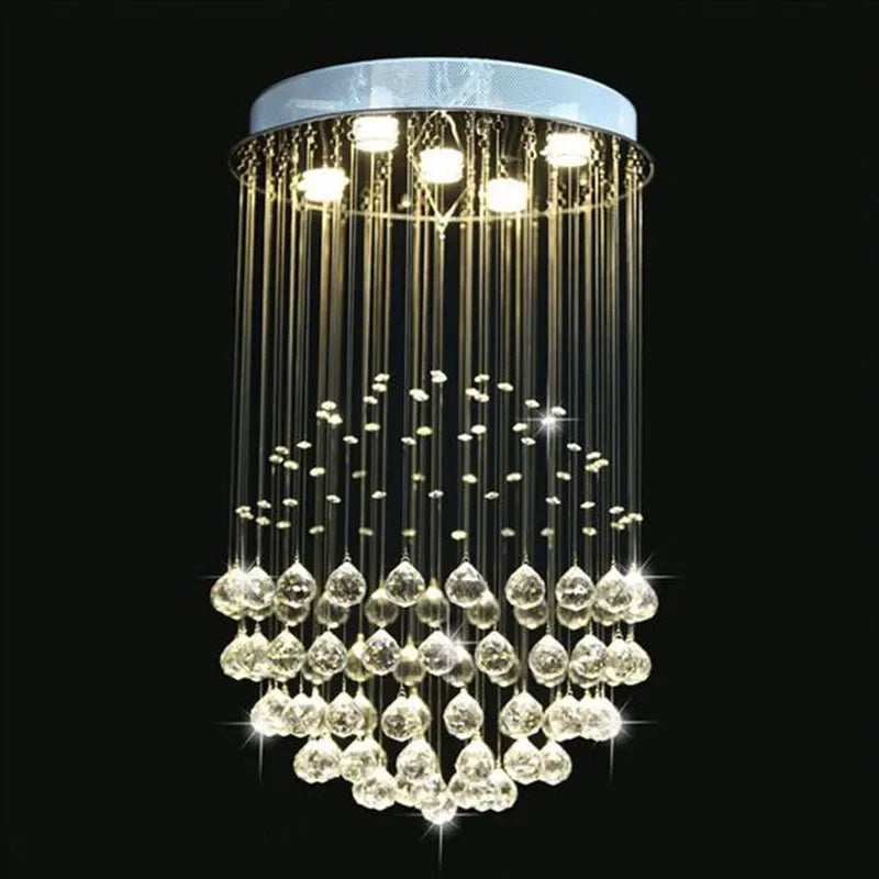 Polished steel Maison Ornate Modern Crystal Chandelier with spherical shape and sparkling LED-lit crystal strands.