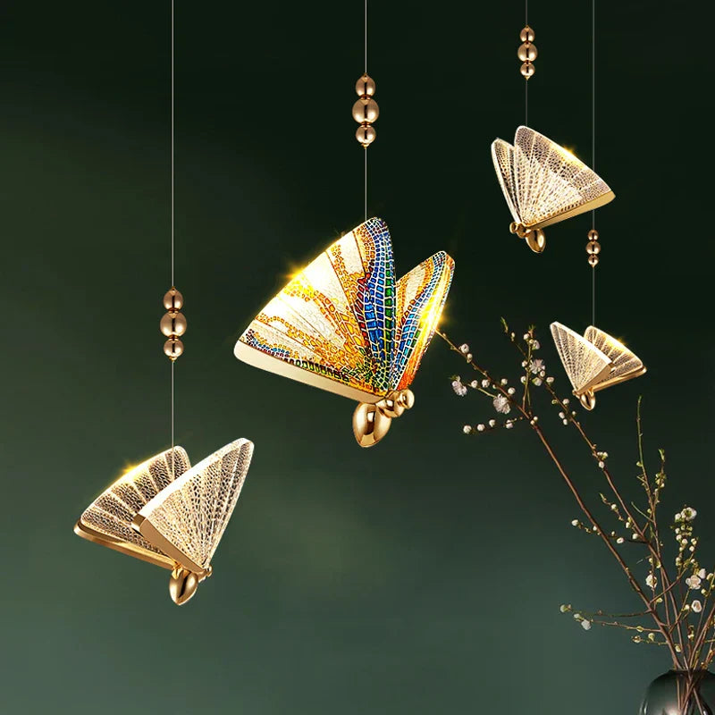 Four Maison Ornate Modern Crystal Chandeliers with gold accents and mosaic-patterned wings, elegantly suspended.