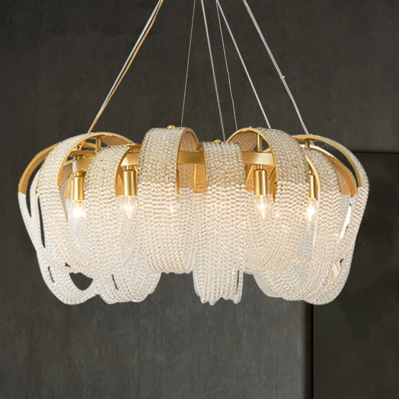 Gold and crystal spiral chandelier with ornate looping bands and multi-wire suspension. Modern, luxurious design.