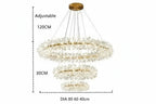 Modern crystal chandelier with three circular LED rings and adjustable cables on a gold base.