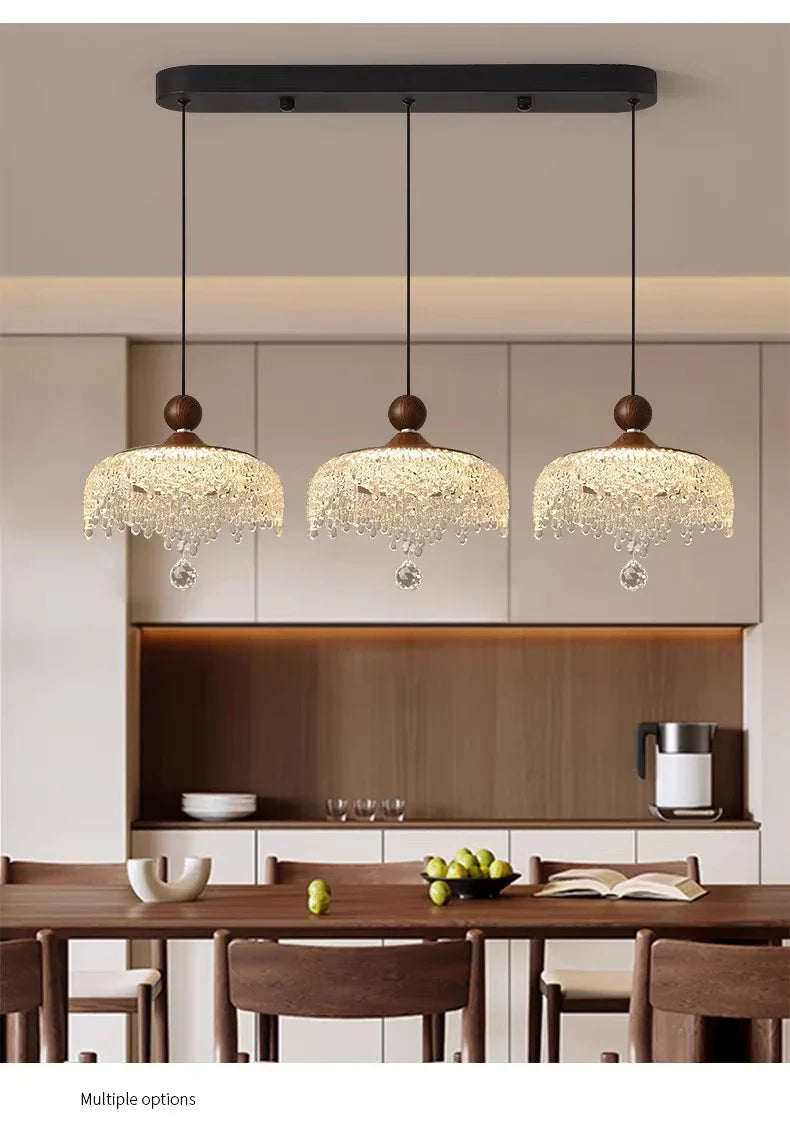 Set of three Maison French Medieval-style crystal teardrop chandeliers with ornate gold detailing.