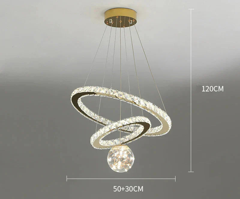 Ornate golden crystal chandelier with dual intertwined LED rings and central starry glass balls.