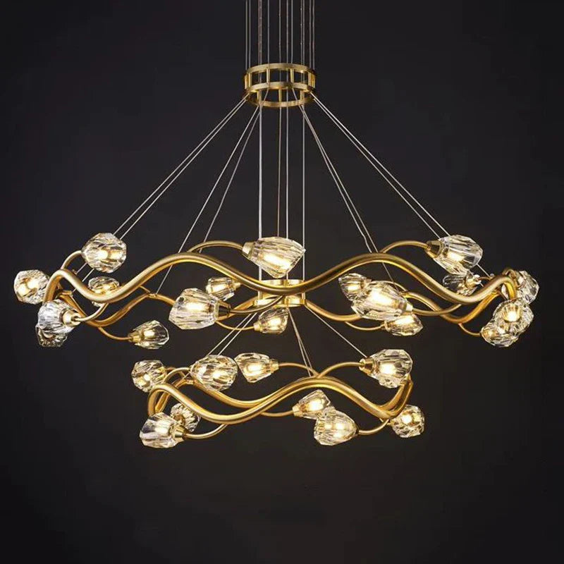 Two intertwined gold rings with crystal-like bulbs, LED chandelier, dimmable, thin suspension wires.