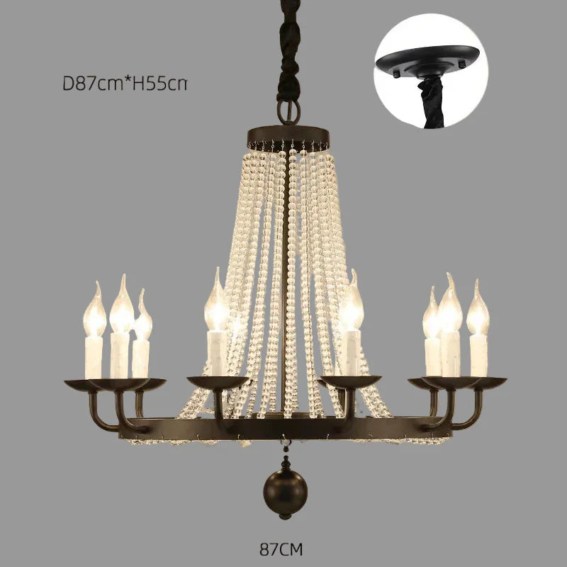 Elegant crystal chandelier with gold accents, tassels, and 8 candle-style bulbs by Maison Ornate.