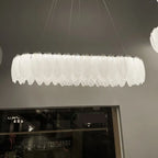 Maison Ornate Crystal Ball Chandelier features decorative feathers and glass, suspended from thin ceiling wires.