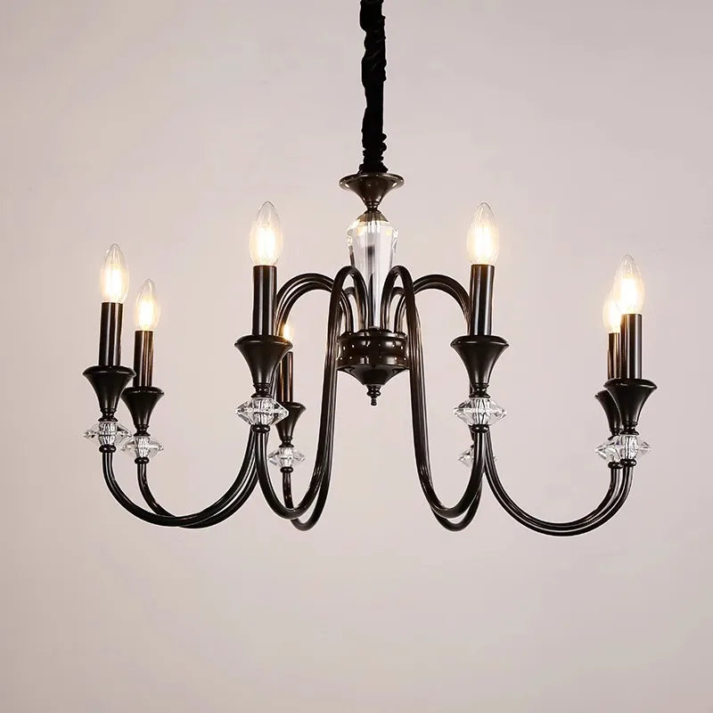 Black and silver vintage chandelier with six candle bulbs, curved arms, and clear crystal accents.