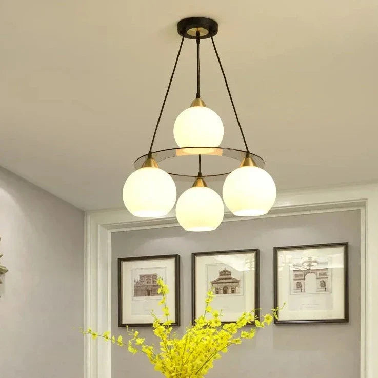 The Maison Ornate Modern Crystal Chandelier features three round heads, elegant crystals, and a sleek modern design.