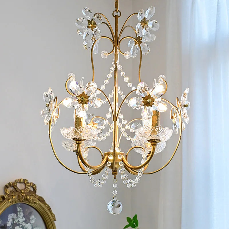 Ornate hallway chandelier with gold accents, curling arms, and crystal beads; glistening pendants.