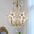 Ornate hallway chandelier with gold accents, curling arms, and crystal beads; glistening pendants.