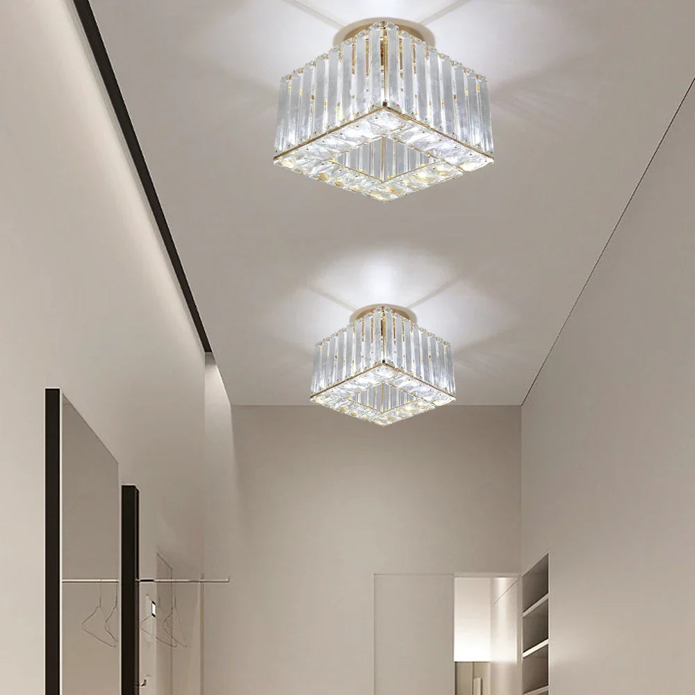 Two Maison Ornate Art Deco crystal chandelier adjustable lights with bright white illumination, geometric ceiling shadows.