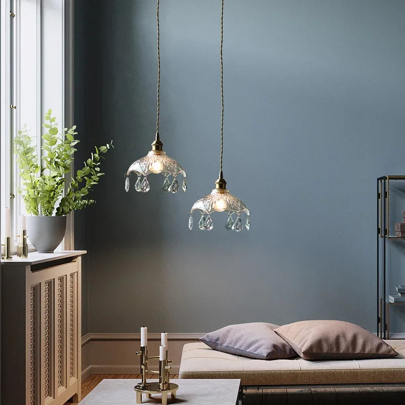 Pair of Maison Ornate Nordic crystal glass chandeliers, elegant cut-glass design, softly glowing overhead.