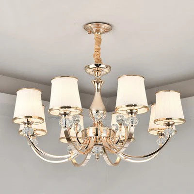 Luxury Baroque Crystal Chandelier with gold finish, six curved arms, white fabric lampshades.