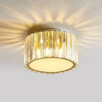 Luxurious round LED chandelier with gold base and vertical crystals, emitting elegant starburst patterns.