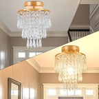 Gold stainless modern crystal Art Deco chandelier with hanging prisms, sparkling clear crystals, warm illuminated glow.