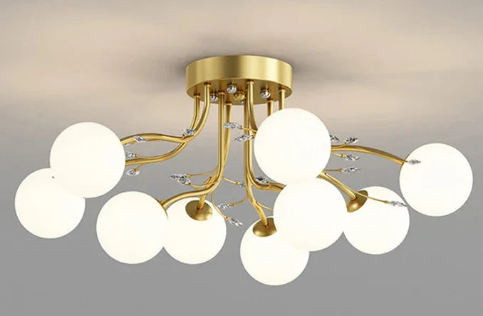 LED star chandelier with gold base, glass globes on curved arms, modern celestial-inspired design.