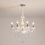 Baroque crystal chandelier with five candle bulbs, curved glass arms, and dangling crystals.