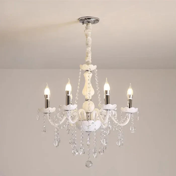 Baroque crystal chandelier with five candle bulbs, curved glass arms, and dangling crystals.