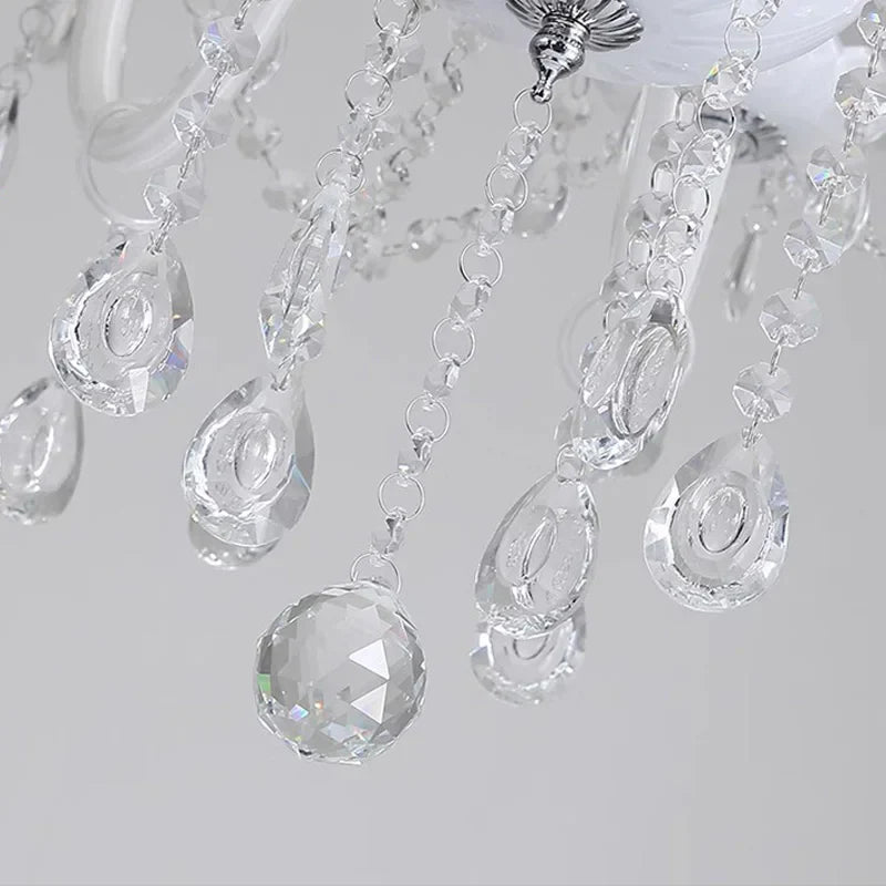 Close-up of Maison Ornate Baroque crystal chandelier droplets and bead strands, reflecting sparkling light.