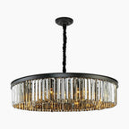 Elegant geometric chandelier with black frame, black cord, and vertical crystal prisms for modern style.