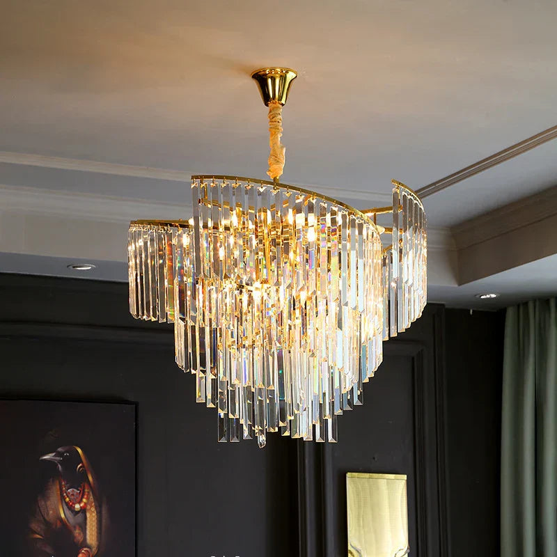 Spiral crystal chandelier with cascading rectangular crystals and gold accents, radiating elegant glamour.