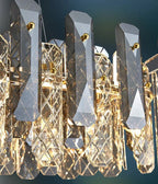 Geometric crystal chandelier with gold accents, featuring LED lights and multifaceted prisms for elegance.
