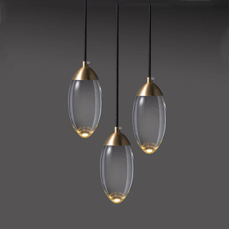 Three oval crystal pendant lights with copper tops form a luxury industrial chandelier design.