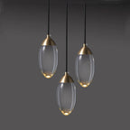Three oval crystal pendant lights with copper tops form a luxury industrial chandelier design.