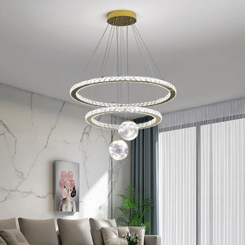 Maison Ornate Golden Crystal Chandelier with LED rings, glass balls, and three illuminated tiers.