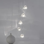 Five ornate modern rotating crystal LED chandeliers hang at various heights, sparkling with elegant reflections.
