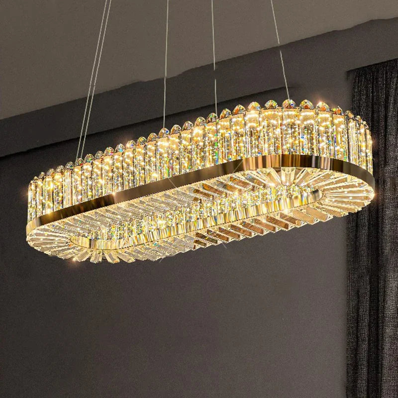 Modern oval gold chandelier with vertically set crystals and warm LED glow, exuding luxury.