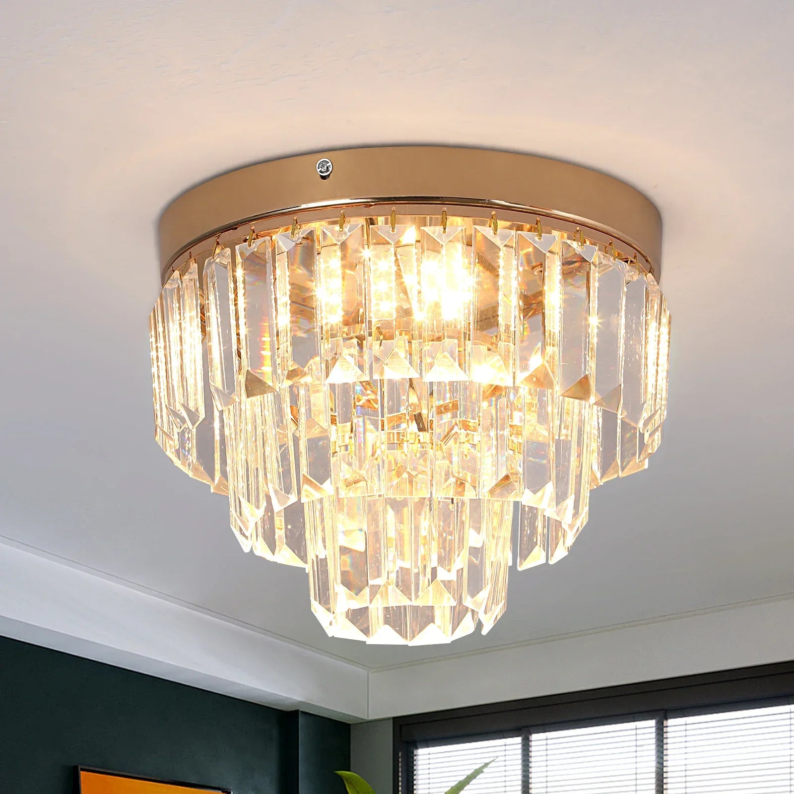 Gold-finished LED chandelier with tiered K9 crystal prisms for a warm, elegant glow.