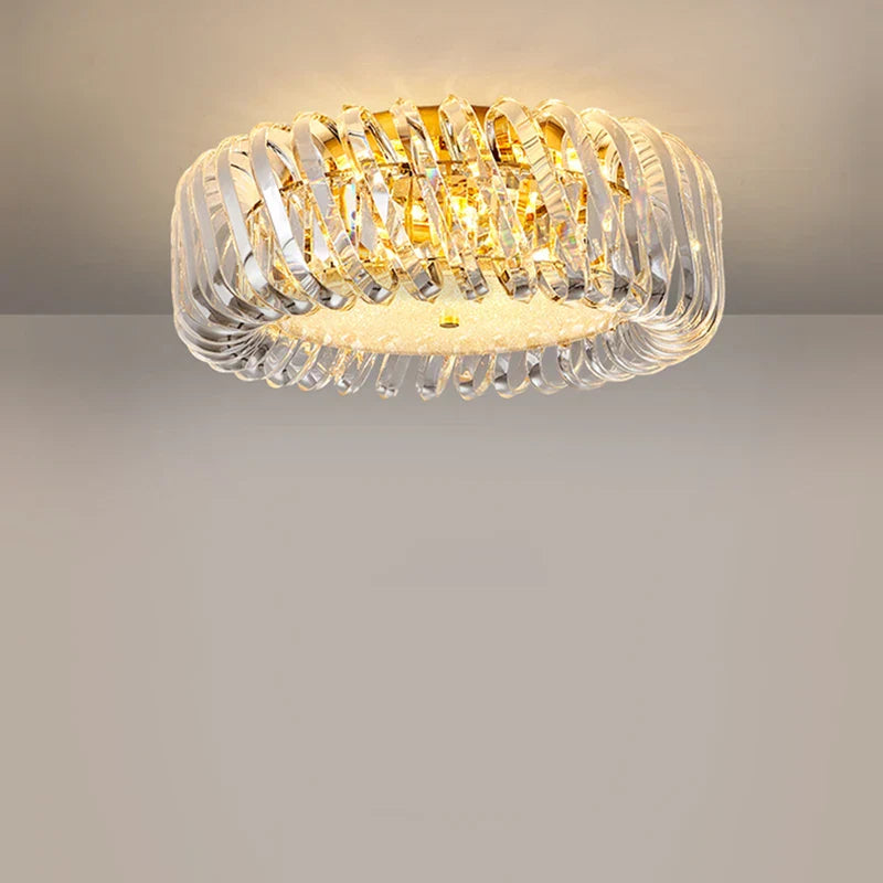 Modern round Maison Ornate LED crystal chandelier with sculptural glass and warm yellow light.