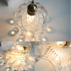 Faceted crystal glass chandelier with hanging ornaments and LED lighting, shown from multiple angles.
