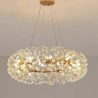 Gold and crystal floral chandelier with ornate metal design, sparkling details, and warm ambient illumination.