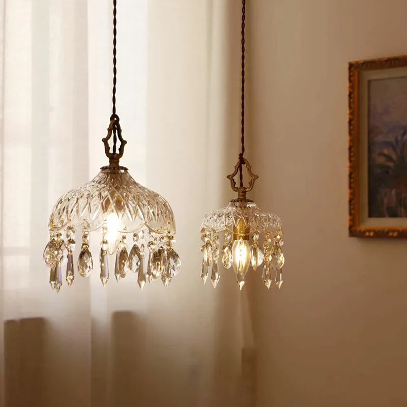 Two ornate Nordic vintage crystal and brass pendant lights glow warmly, showcasing elegant glass accents.