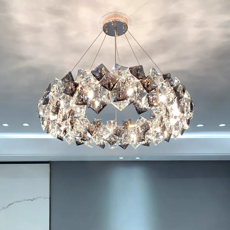 Elegant modern stainless steel crystal LED chandelier with geometric details, sparkling light, and radiant reflections.