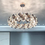 Elegant modern stainless steel crystal LED chandelier with geometric details, sparkling light, and radiant reflections.