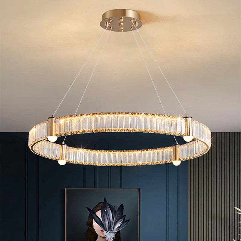 Gold-finished Nordic crystal chandelier with LED rings, suspended by four thin wires, modern elegance.