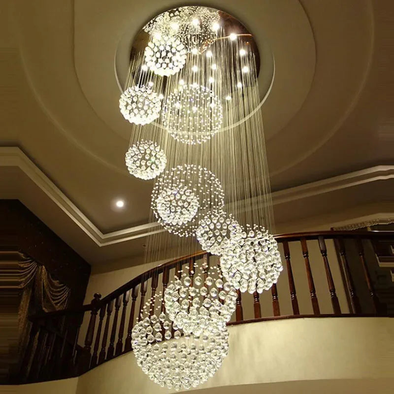 Modern stainless steel chandelier with multiple crystal spheres at varied heights, smart compatible lighting.