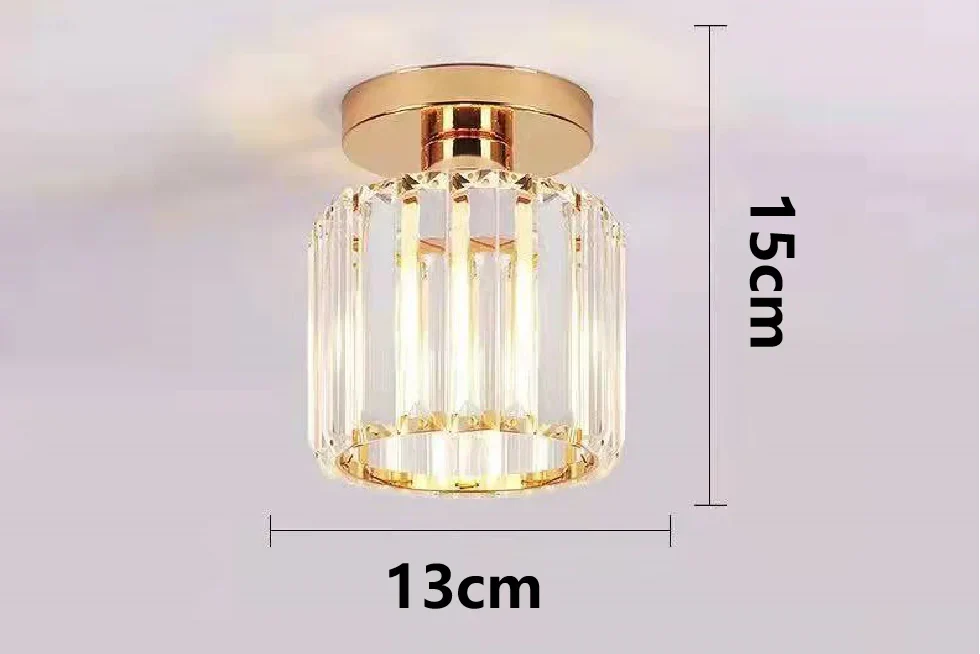 Gold and crystal cylindrical chandelier with airy suspension, variable shape, sleek modern design.