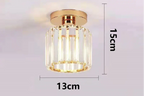 Gold and crystal cylindrical chandelier with airy suspension, variable shape, sleek modern design.