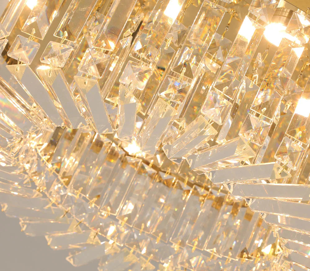 Close-up of Maison Ornate Modern Gold Crystal Chandelier with LED lighting and sparkling glass prisms.