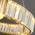 Close-up of Maison Ornate Nordic LED chandelier with gold frame and sparkling crystal prisms.