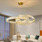 Maison Ornate chandelier with three overlapping gold rings and crystal glass details, modern industrial style.